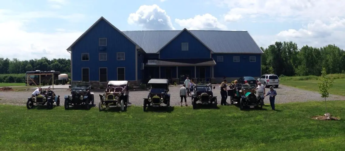 A group of old cars parked in front of a building.