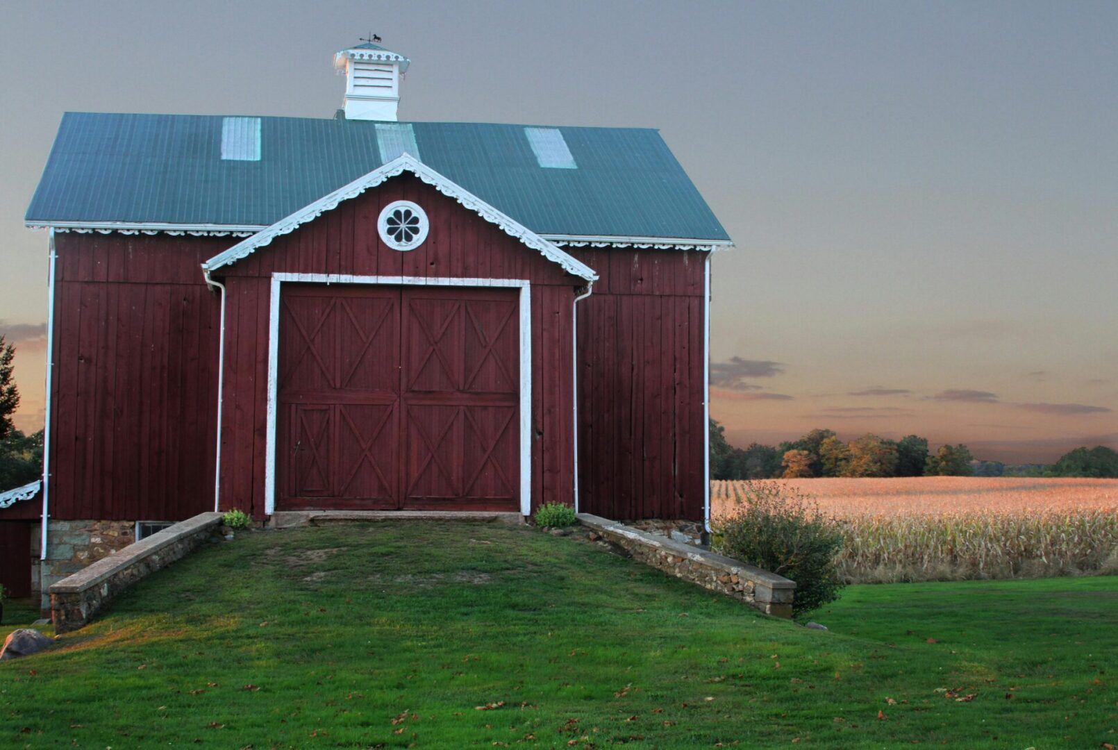 A red barn with a blue roof and white trim.